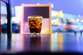 Sparking water soda or cola in the glass on the table with bokeh in the night