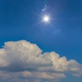 Sparkle sun above dense cumulus clouds Royalty Free Stock Photo