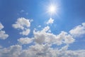 Sparkle sun on blue cloudy sky background Royalty Free Stock Photo