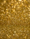 A glittery gold paper. Golden glitter light bokeh abstract texture. Pattern designs. Sparkle wallpaper for Christmas Royalty Free Stock Photo