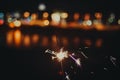 Sparkler against citylights Royalty Free Stock Photo