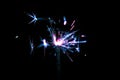 Sparkler in blue and white light on a black background Royalty Free Stock Photo