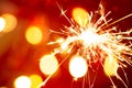 Sparkler on bokeh red background Royalty Free Stock Photo