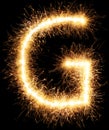 Sparkler firework light alphabet G on black Royalty Free Stock Photo