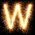 Sparkler firework light alphabet W on black Royalty Free Stock Photo