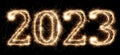 2023 sparkler golden number bright gold fireworks display black. dark celebration happy new year eve change of the year concept Royalty Free Stock Photo