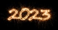 2023 sparkler golden number bright gold fireworks display black. dark celebration happy new year eve change of the year concept Royalty Free Stock Photo