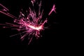 Sparkler in pink and white light on a black background Royalty Free Stock Photo