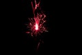 Sparkler in red and white light on a black background Royalty Free Stock Photo