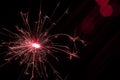 Sparkler in red and white light on a black background Royalty Free Stock Photo