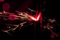 Sparkler in red and white light on a black background Royalty Free Stock Photo