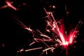 Sparkler in red and white light on a black background Royalty Free Stock Photo