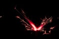 Sparkler in red and white light on a black background Royalty Free Stock Photo