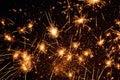 Sparklers on a black background, golden sparks, festive atmosphere, background