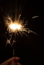 Sparklers in the dark. Sparks with fire in hands on a stick. Awesome
