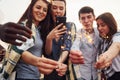 With sparklers in hands. Group of young people in casual clothes have a party at rooftop together at daytime Royalty Free Stock Photo