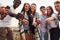 With sparklers in hands. Group of young people in casual clothes have a party at rooftop together at daytime Royalty Free Stock Photo