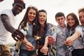 With sparklers in hands. Group of young people in casual clothes have a party at rooftop together at daytime Royalty Free Stock Photo