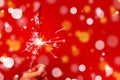 Sparklers on a red background and beautiful snowflakes. New Year and Christmas card. Royalty Free Stock Photo