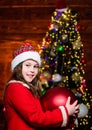 Sparkling big toy. Festive atmosphere christmas day. Girl santa claus costume hold big ball christmas tree ornaments Royalty Free Stock Photo