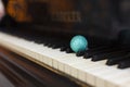 Sparkling blue and silver Christmas ball on piano keys Royalty Free Stock Photo