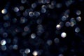 Sparkling bokeh lights on a dark background with hexagonal shapes and soft glow