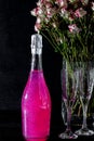 Sparkling brilliant raspberry drink. Champagne in two glasses stands on a wooden table with ice. For flowers and a garland Royalty Free Stock Photo