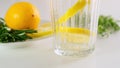 Sparkling club soda with slice of lemon in the glass. Pour minreral water. Close up. Royalty Free Stock Photo