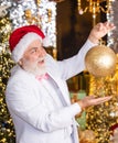 Sparkling decorations. Decorating home. Christmas spirit. Christmas decoration. Santa Claus. Mature man with white beard Royalty Free Stock Photo