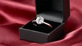 A sparkling diamond engagement ring in a black box, resting on luxurious red satin Royalty Free Stock Photo