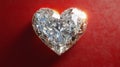 A sparkling diamond heart rests on a red background Royalty Free Stock Photo