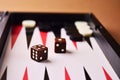 Sparkling dice brown on the playing field for backgammon close-up Royalty Free Stock Photo