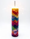 Sparkling Firework Candle with Colorful Chevron Pattern on White Background Royalty Free Stock Photo