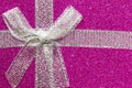 Sparkling gift box or present with bow ribbon on magic Background with glitters Copy space for greeting text. pink and Yellow Royalty Free Stock Photo