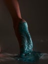 Sparkling glittering body art on female leg, close up of woman's sole feet in blue brilliance glitter, podiatry concept Royalty Free Stock Photo