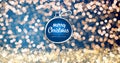 Sparkling gold and silver xmas lights with Merry Christmas and Happy New Year greeting message ball ornament on blue Royalty Free Stock Photo