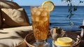 sparkling golden vodka drink with ice and lemon on the beach while enjoying the crashing waves on a sunny day Royalty Free Stock Photo