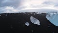 Ice rocks over black sand beach at Diamond beach Iceland - space for copy