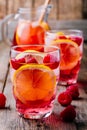 Sparkling Lemon Raspberry Lemonade Sangria in glass on wooden background Royalty Free Stock Photo