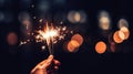 Sparkling Moments Hand Holding Burning Sparkler Blast on Black Bokeh Background, Igniting Holiday Celebration Event Party with Royalty Free Stock Photo