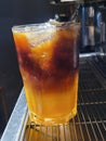 Sparkling orange pouring single shot espresso