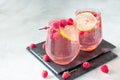 Sparkling pink raspberry lemonade on grey background