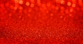 Sparkling red gold glitter background with bokeh. Closeup view, dof. Pattern with shining fine red sequins. Festive luxury Royalty Free Stock Photo