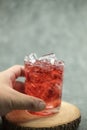 Sparkling red water soda with ice cubes. Summer iced drink Royalty Free Stock Photo