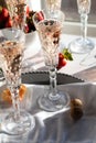 Sparkling rose wine in beautiful crystal flute glasses with bright sunshine streaming in.