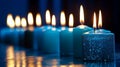 Sparkling row of diverse candles lighting up a blue setting Happy birthday card idea Royalty Free Stock Photo