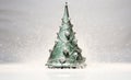 Sparkling Surprise: A Miniature Silver Christmas Tree Shines Brightly in a Sea of Green