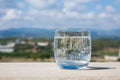 Sparkling water glass on a stone parapet with a mountain view. Cool glass of mineral water. Mountain mineral water Royalty Free Stock Photo