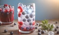 Sparkling water with raspberries and blueberries. Refreshing drinks with ice cubes with fruits , ice with blackberries and Royalty Free Stock Photo