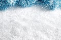 Sparkling white snow foreground with blurred artificial blue fir branches and falling snow or glitter in the background. Bright Royalty Free Stock Photo
